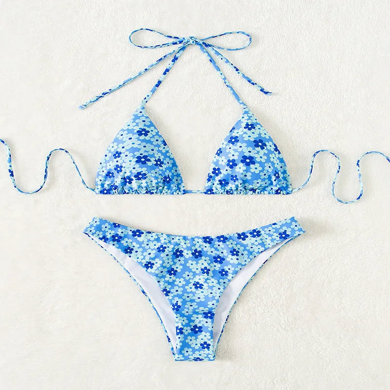 Women's blue printed swimsuit with lace-up front and split shorts on white background