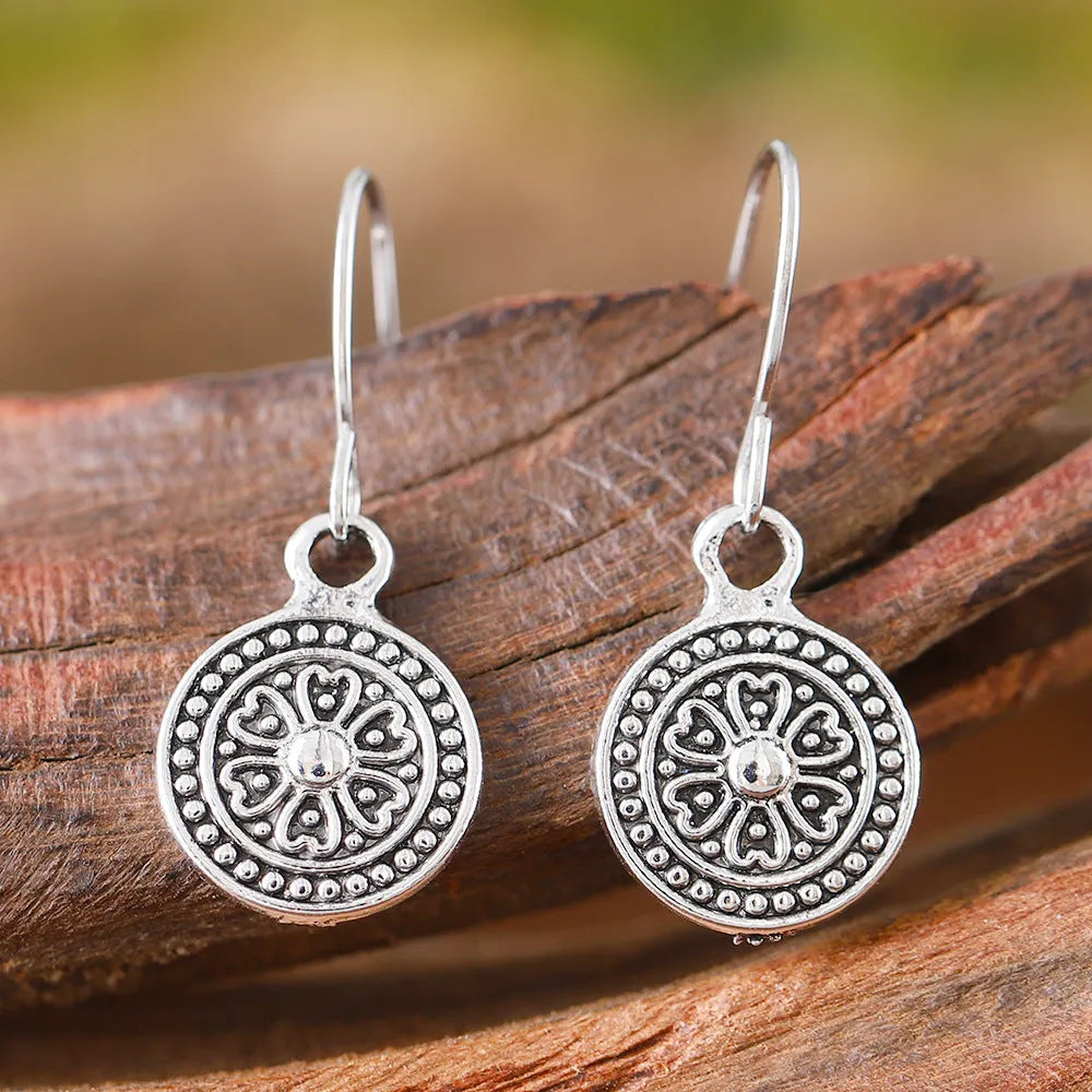 Geometric round women's earrings with distressed ethnic print in retro bohemian style.