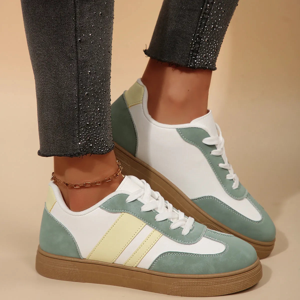 Green women's retro sports low-top shoes with cross straps and round toe on a rubber sole.
