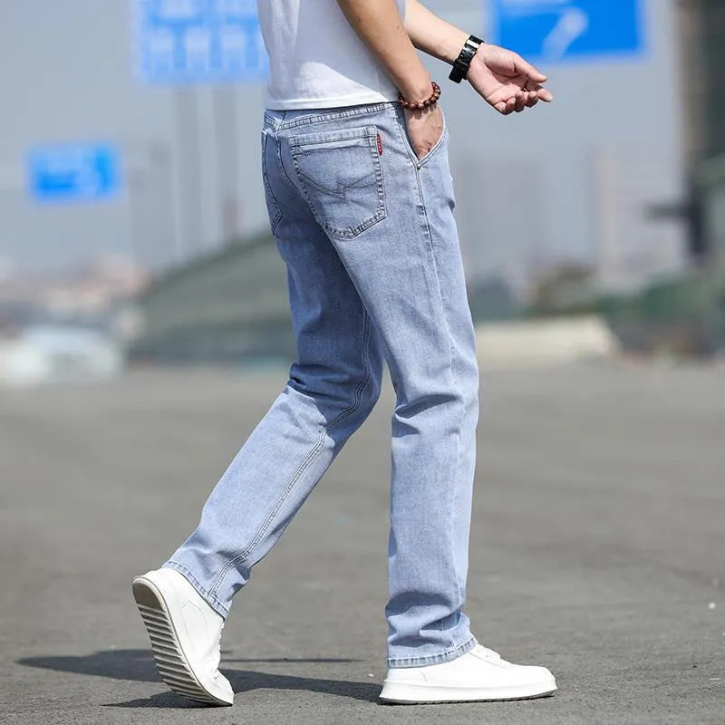 Men's smoky gray straight tube jeans with low waist and zipper fly closure