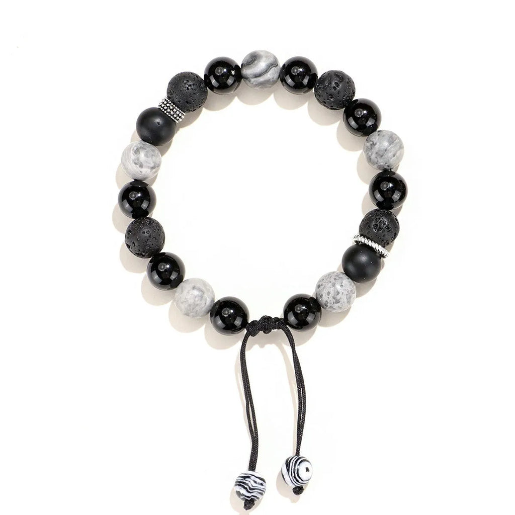 Black agate map stone volcanic rock bracelet in diamond shape, New Chinese style, on wrist.