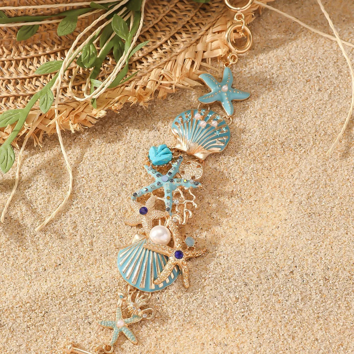 Women's alloy rhinestone bracelet with a nautical boat anchor and starfish design in blue coral colour.