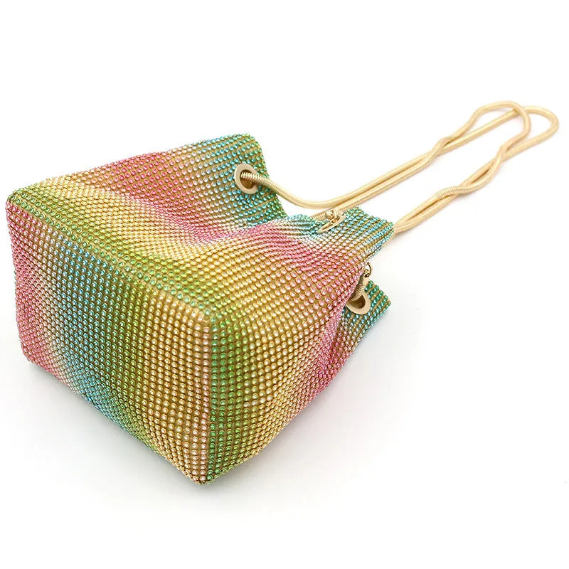 Colourful rainbow design rhinestone bucket bag with a soft fabric texture and a handle.