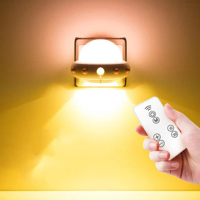 Remote control UFO shaped bedside night light in blue, pink, or white with cartoon design