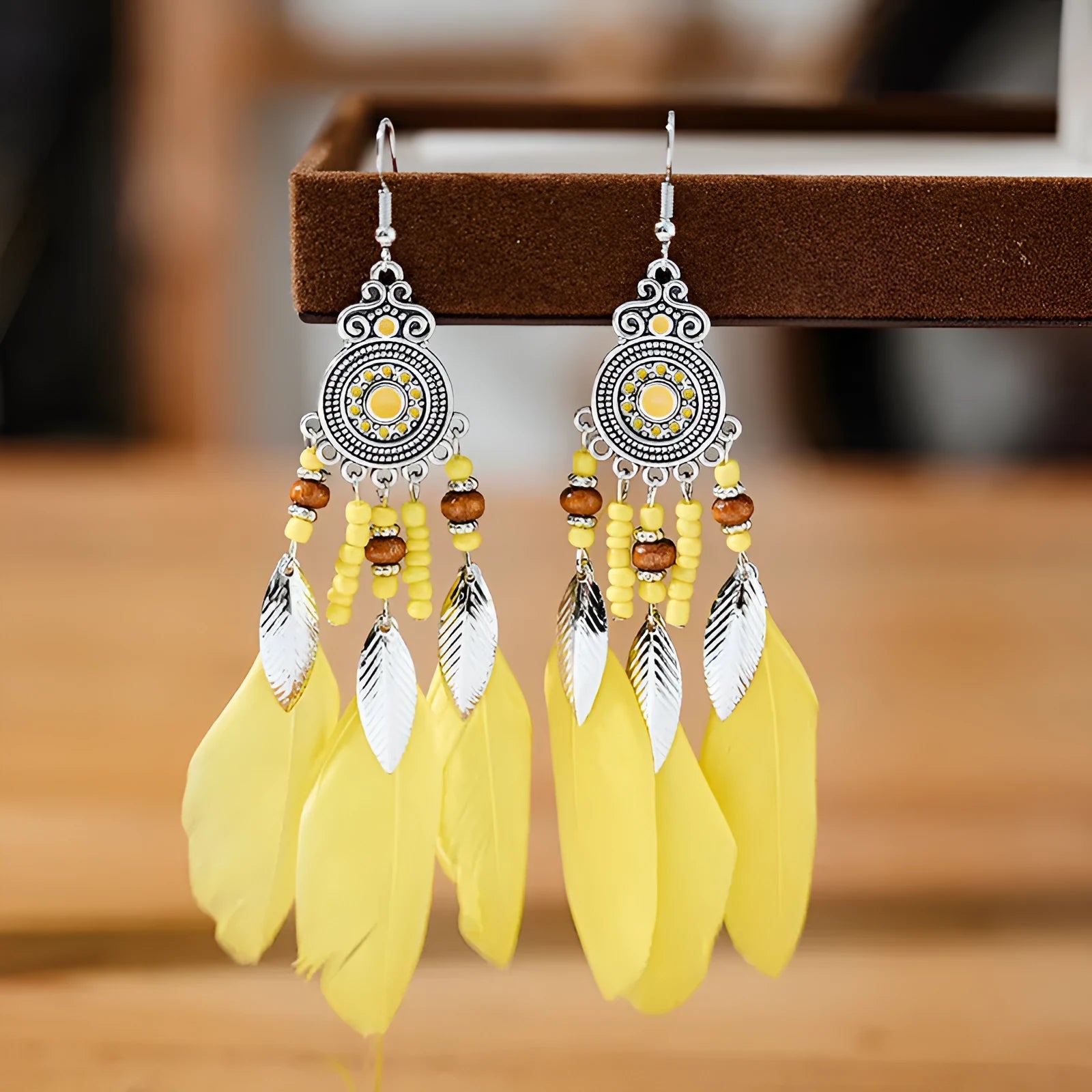 Round drop feather design alloy earrings with leaf pattern in a bohemian style, showing electroplated finish.