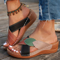 Women's black cross-strap peep-toe slippers with a thick polyurethane sole on a white background.
