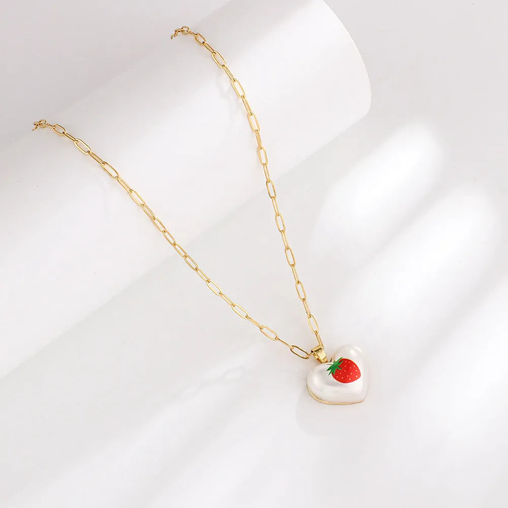 Geometric fruit charm necklace with an adjustable chain, shown in strawberry, pineapple, apple, pear, and cherry colour variants.