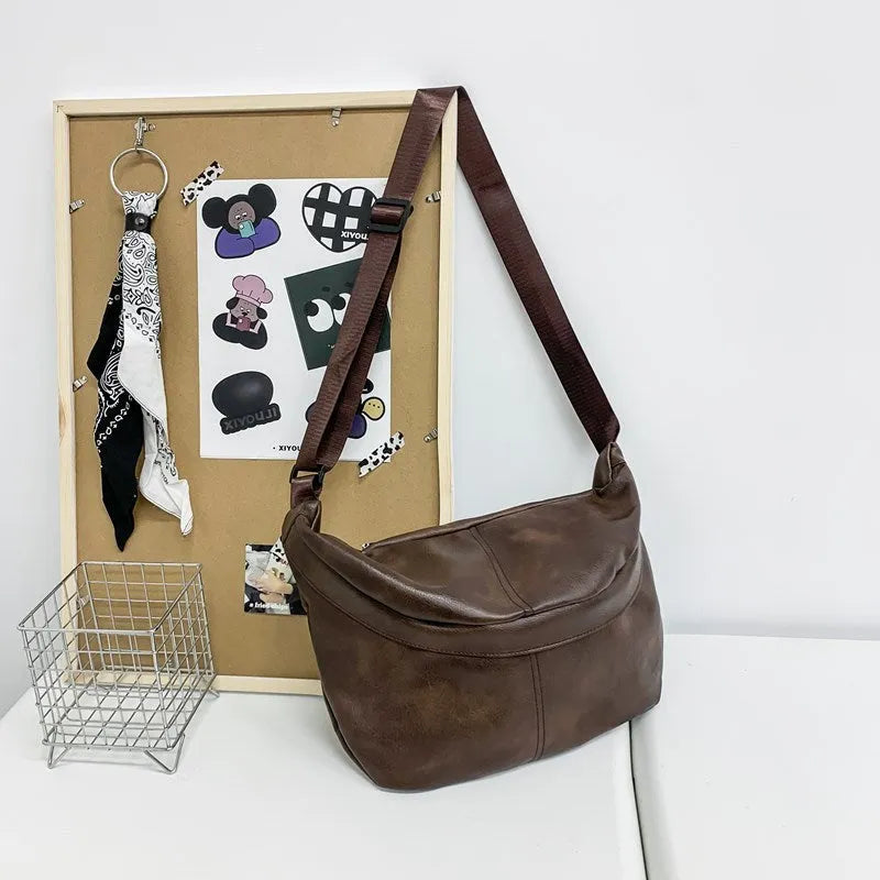 Retro large capacity men's crossbody bag in brown PU leather with zipper closure on white background.