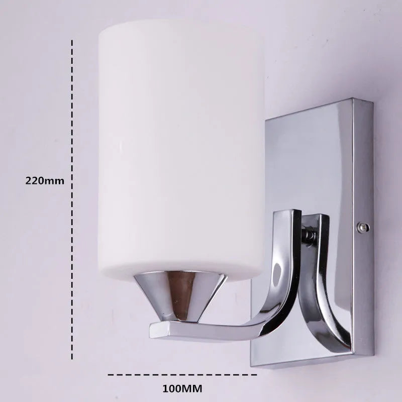 Minimalist chrome-finished glass wall lamp with single head configuration on white wall