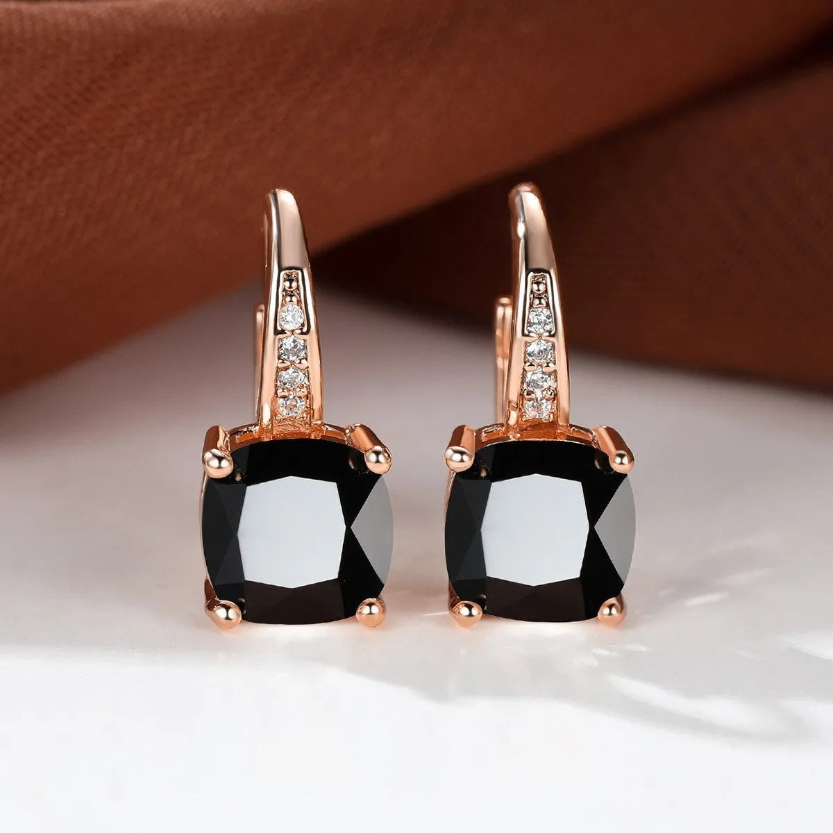 Square geometric ear hook studs with a round zircon stone, shown in a gold electroplated finish.