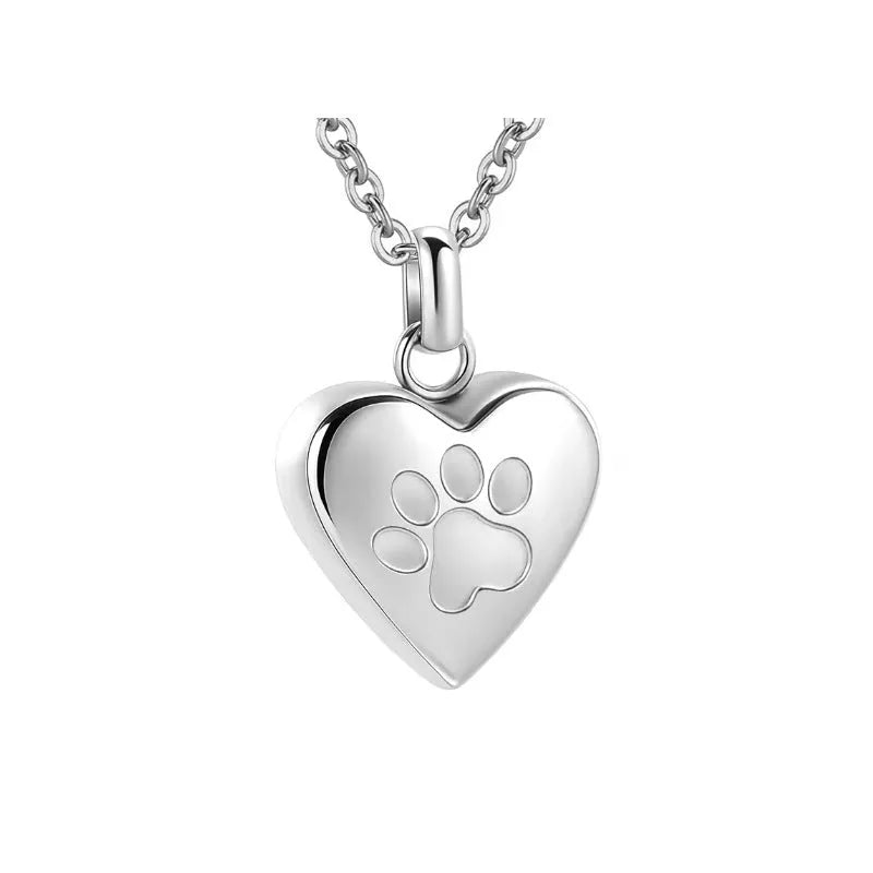 Openable heart-shaped cinerary casket necklace with paw print, made from polished titanium steel.