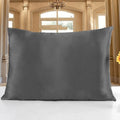 19 M double-sided silk pillowcase in apricot colour on a bed.