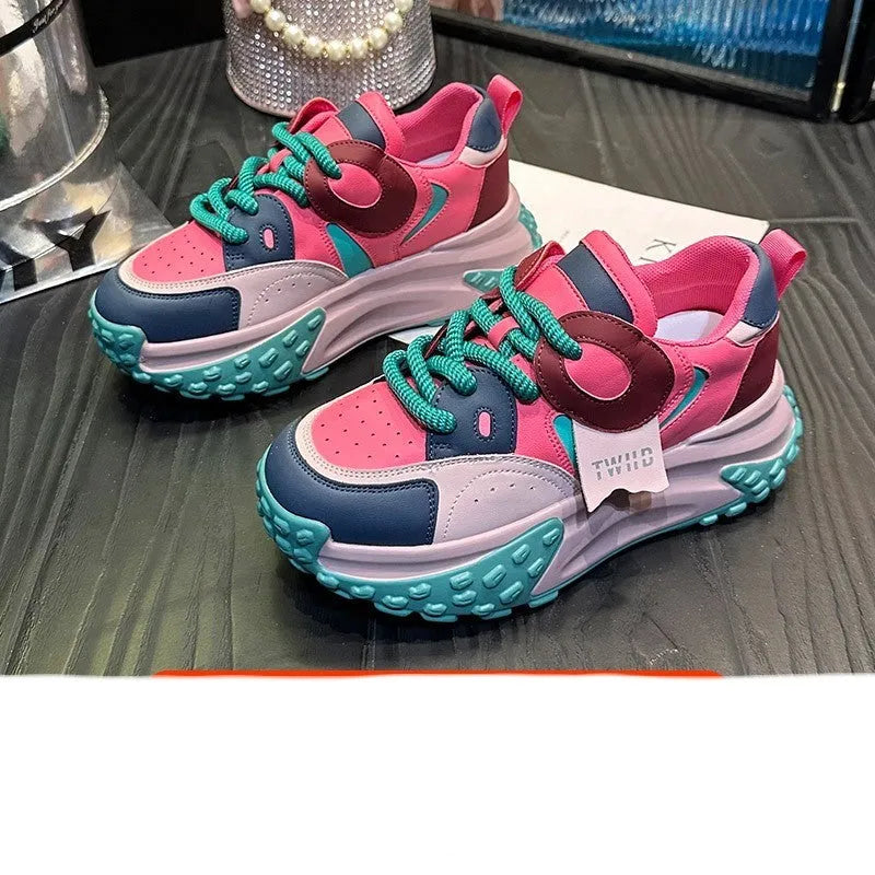 A pair of thick-soled leather casual shoes with a wedge heel and front lace-up design.