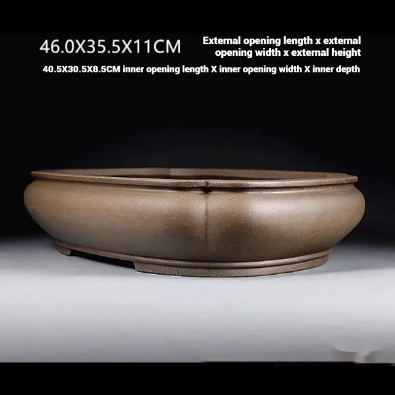 Handmade antique papaya-shaped purple clay flower pot for plants.