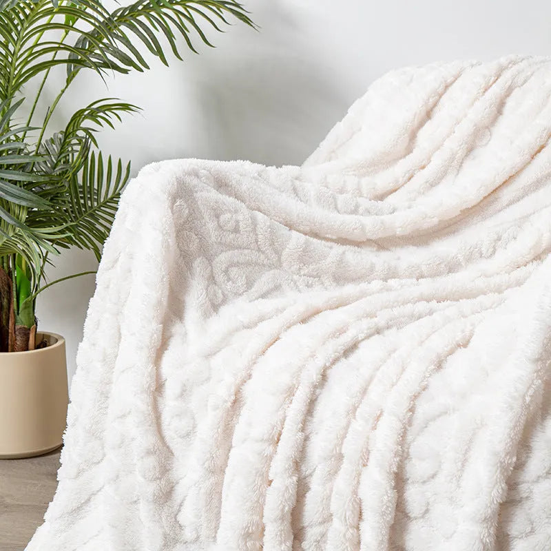 Shu Cotton Velvet Jacquard blanket in fog blue with a woven plant flower pattern, laid flat.