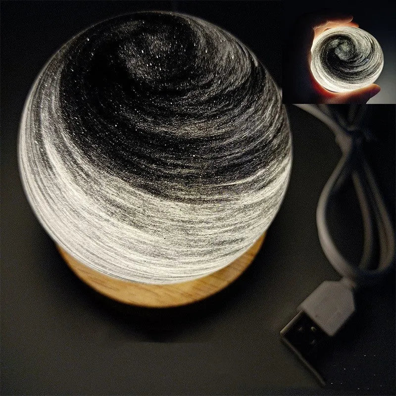 Planet night light with USB cable and base in modern simple design showing spherical shape