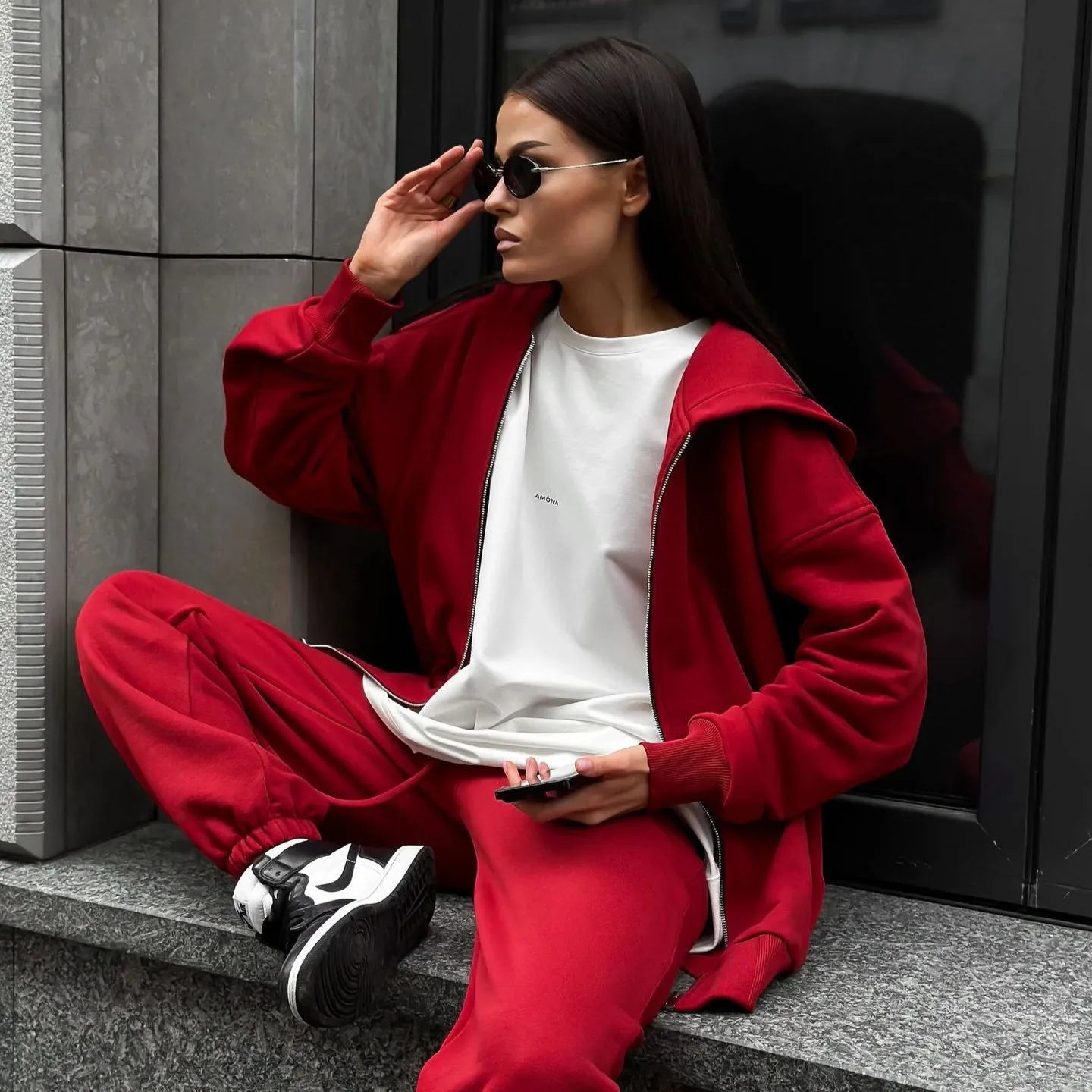 Women's red street style two-piece set with long-sleeved coat and matching trousers, loose fit.