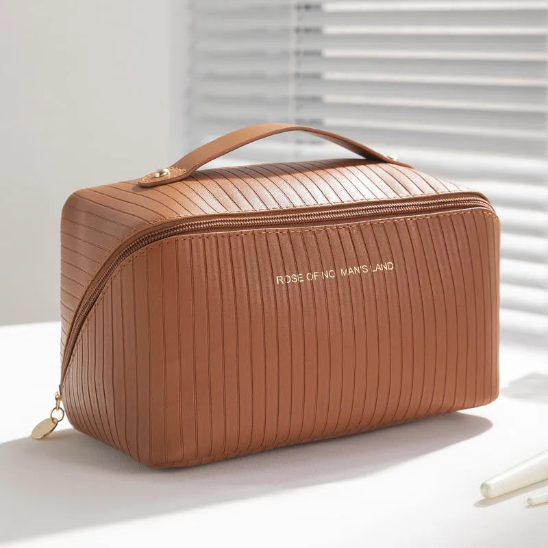 Beige cubic PU vertical pattern pillow makeup bag for travel, showing dimensions of 22.5cm by 12.5cm.