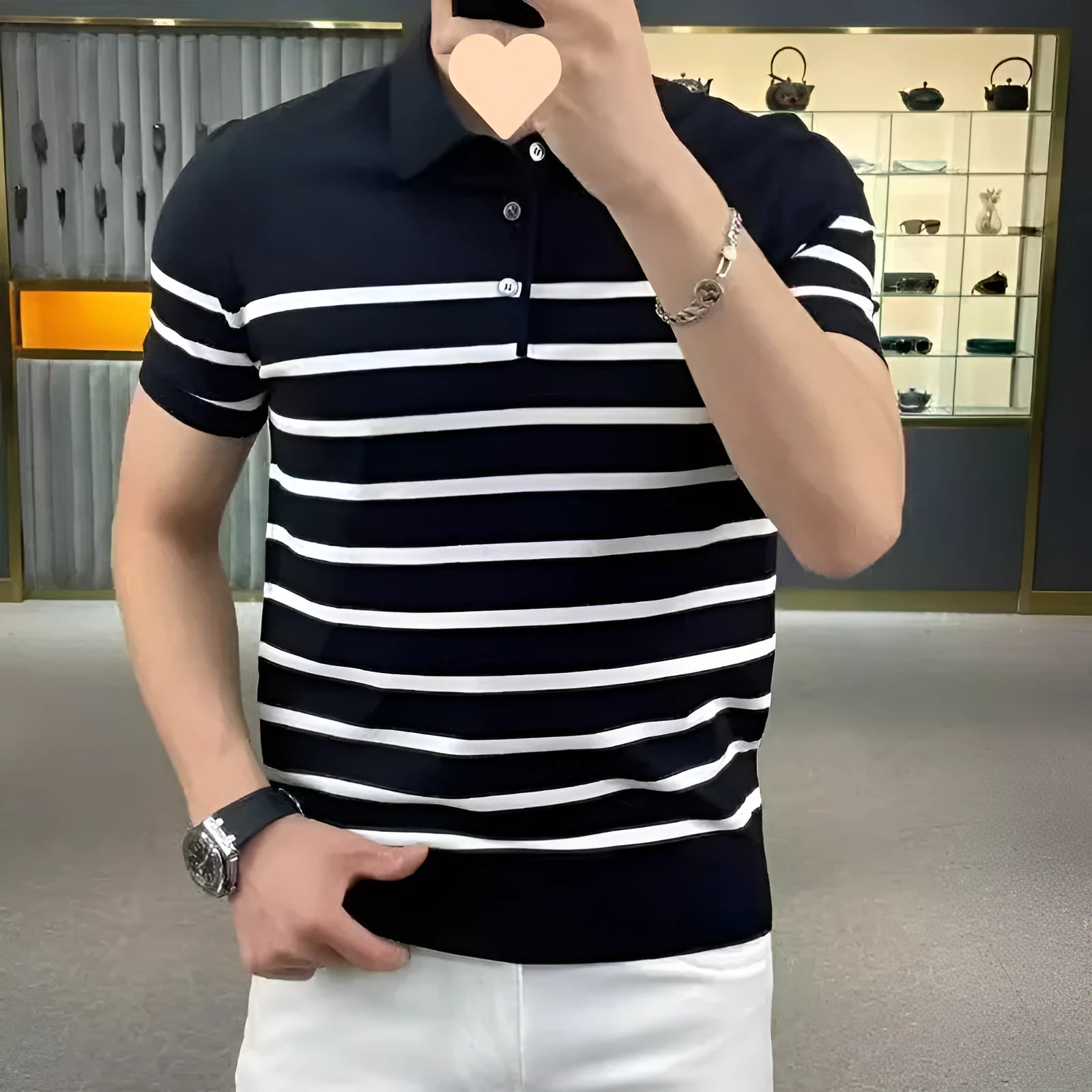 Black and white striped pullover T-shirt with a lapel-style neckline laid flat.