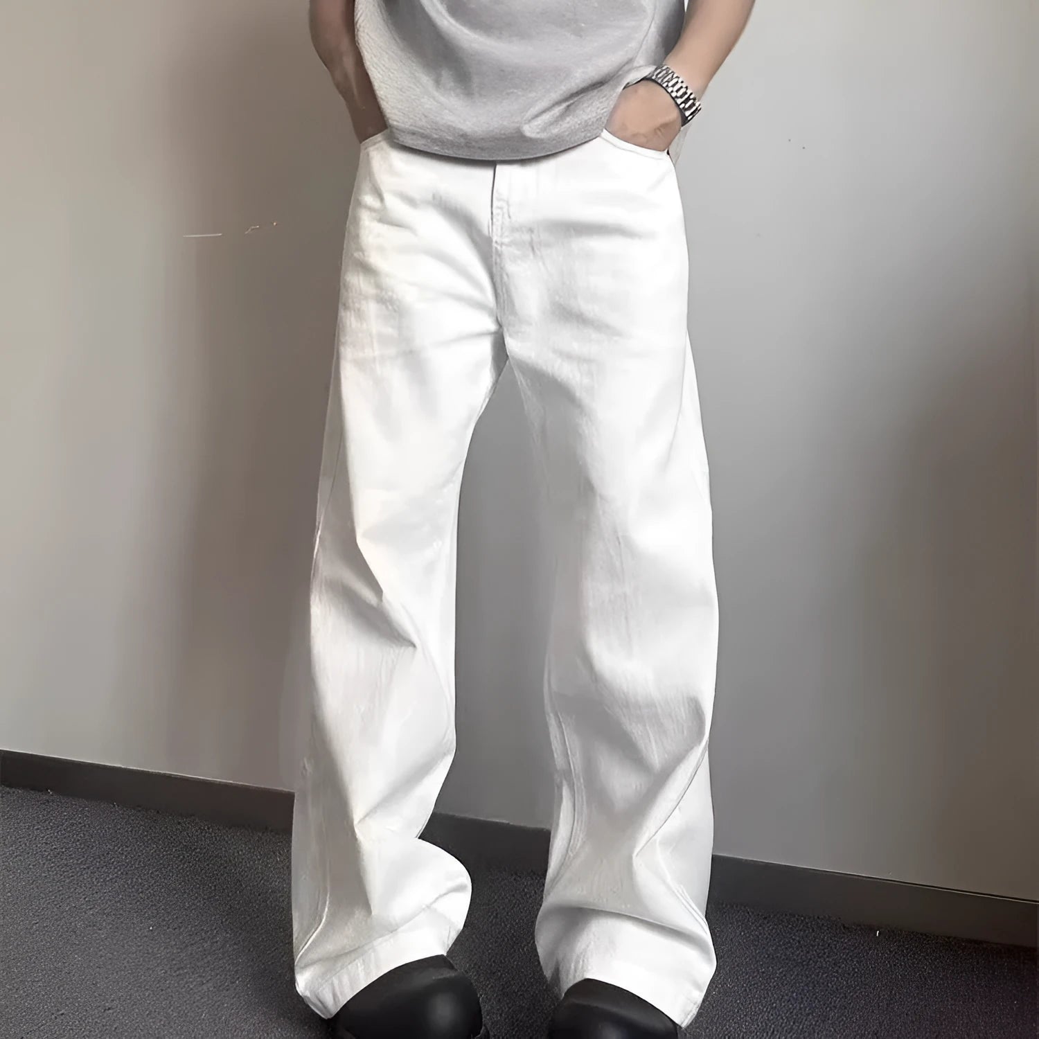 Men's white straight-leg wide-leg cotton denim jeans on a plain background.