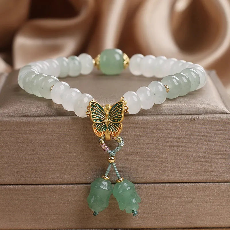 Green crystal women's bracelet with abacus beads, butterfly tassel, rhinestones and pearls