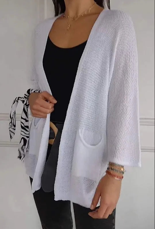 Women's army green waffle weave cardigan coat with nine-quarter length sleeves and pockets.