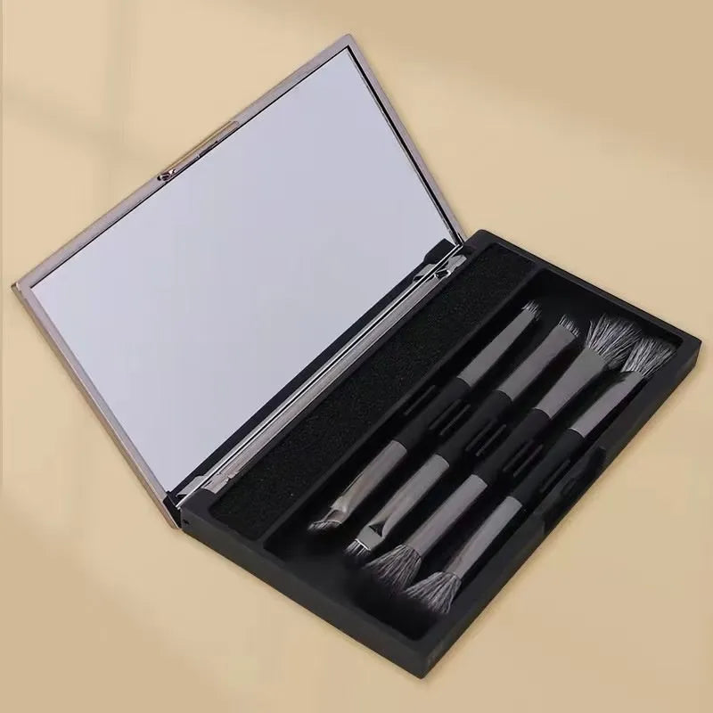 Makeup brush set in case with mirror showing 4 or 5 artificial fibre brushes in silver, gold or sparrow design