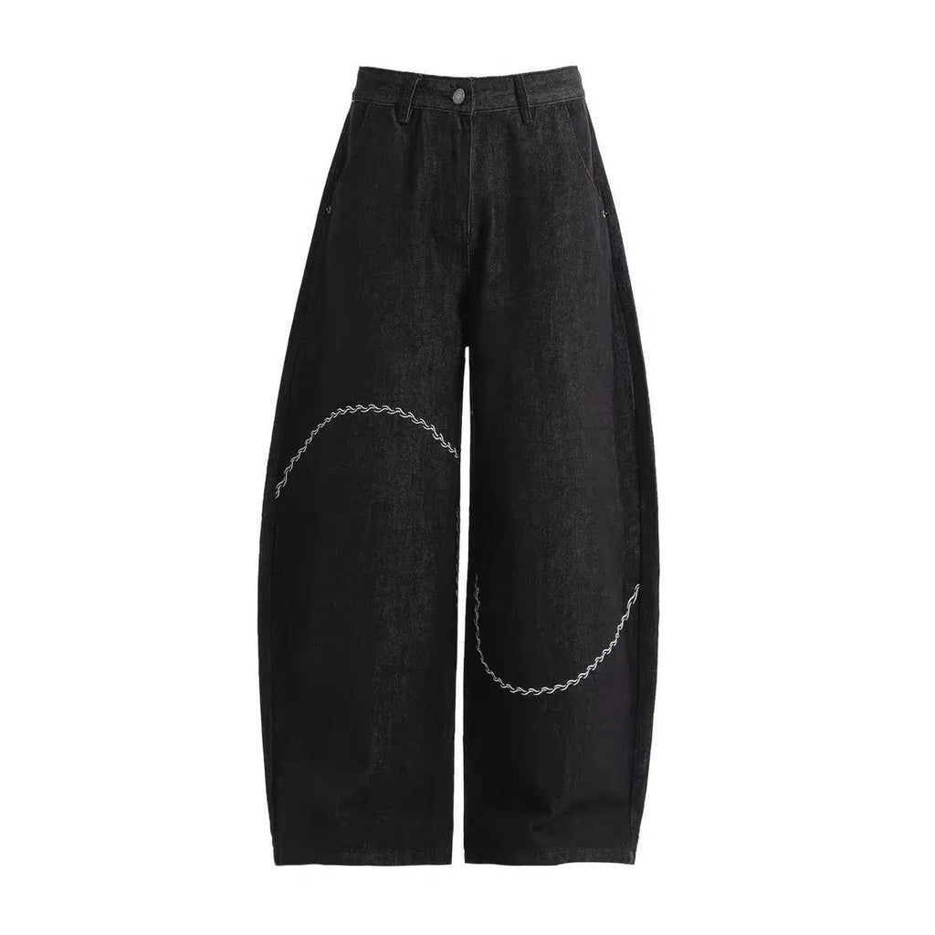 Black straight-leg denim trousers with a mid-waist and zip fly, laid flat.