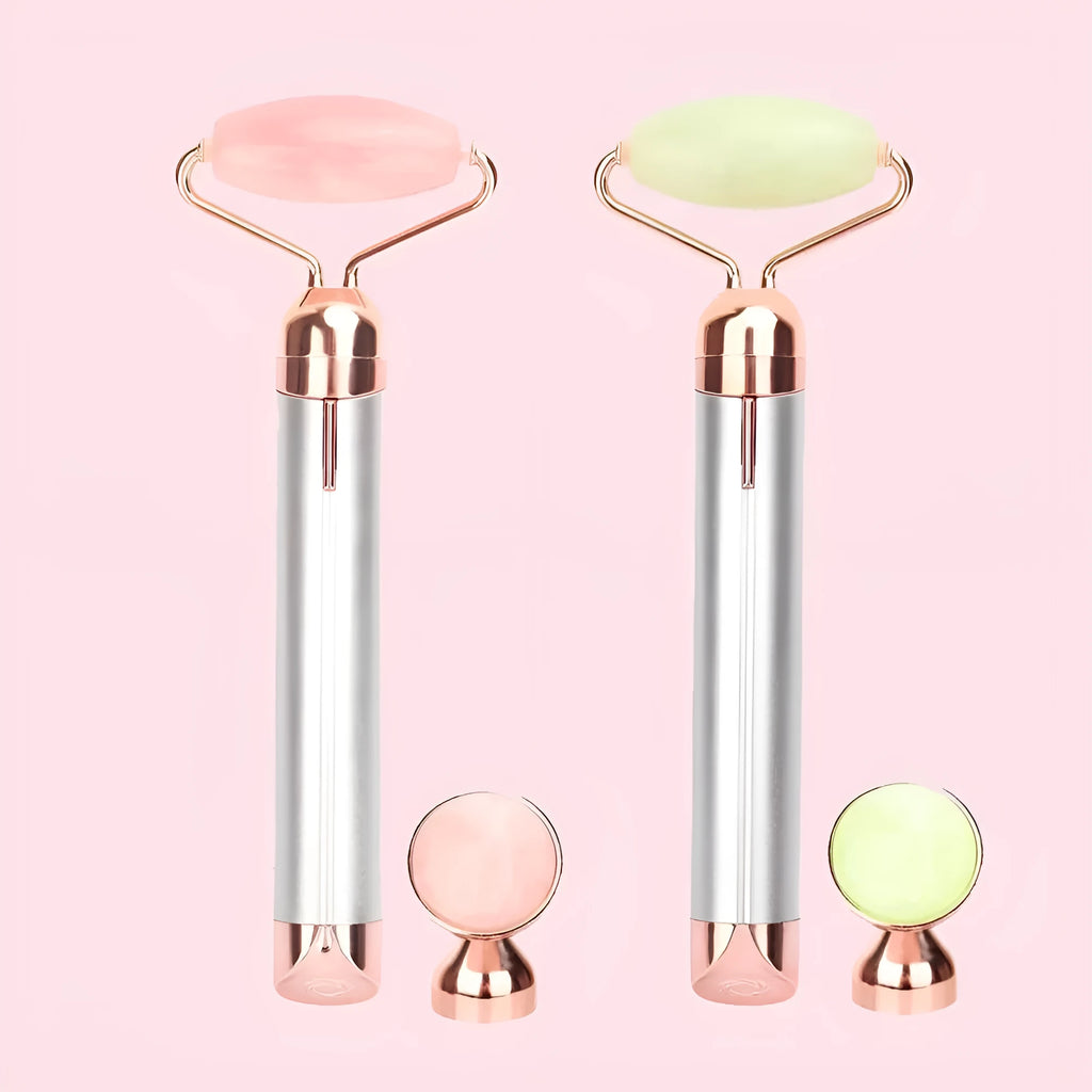 Electric vibrating rose quartz facial roller with under eye press on pink background