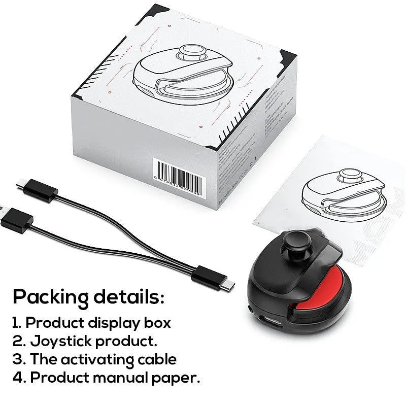 Black and white USB gaming stick controller on a desk, showing compact square design.