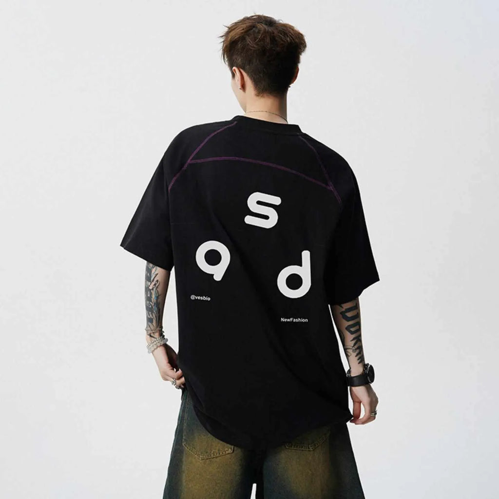 A loose-fitting black cotton t-shirt with letter print detail on the front, showing short sleeves and a round neck.
