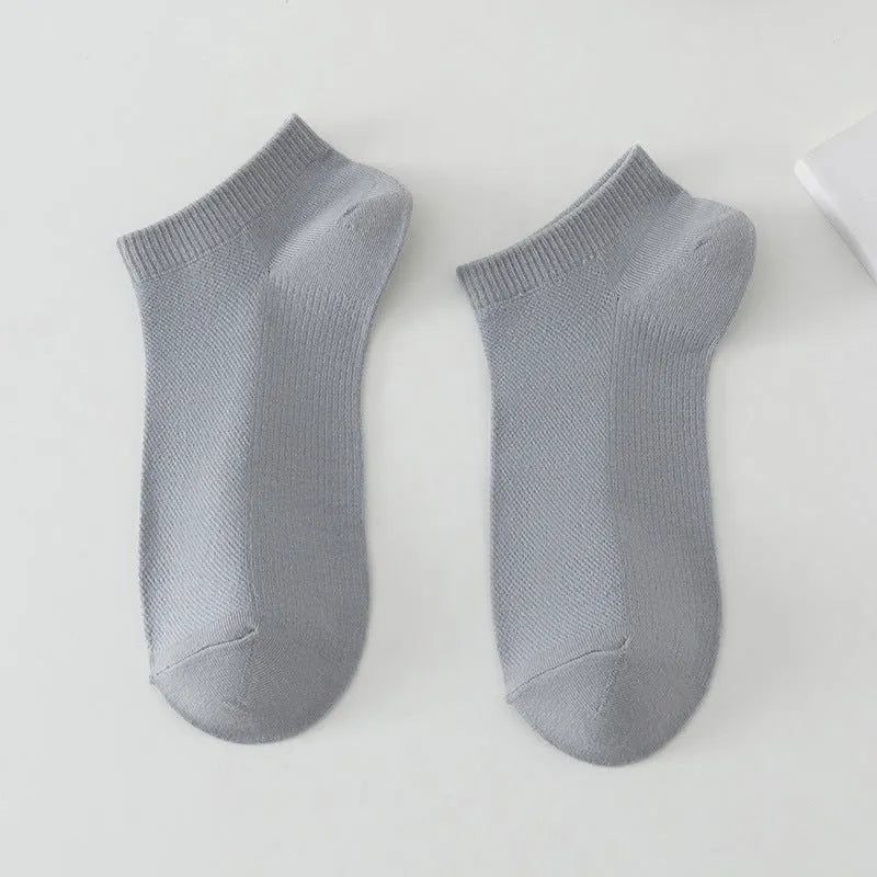Men's low-cut solid colour boat socks made from breathable polyester, shown in one of six available colour options.