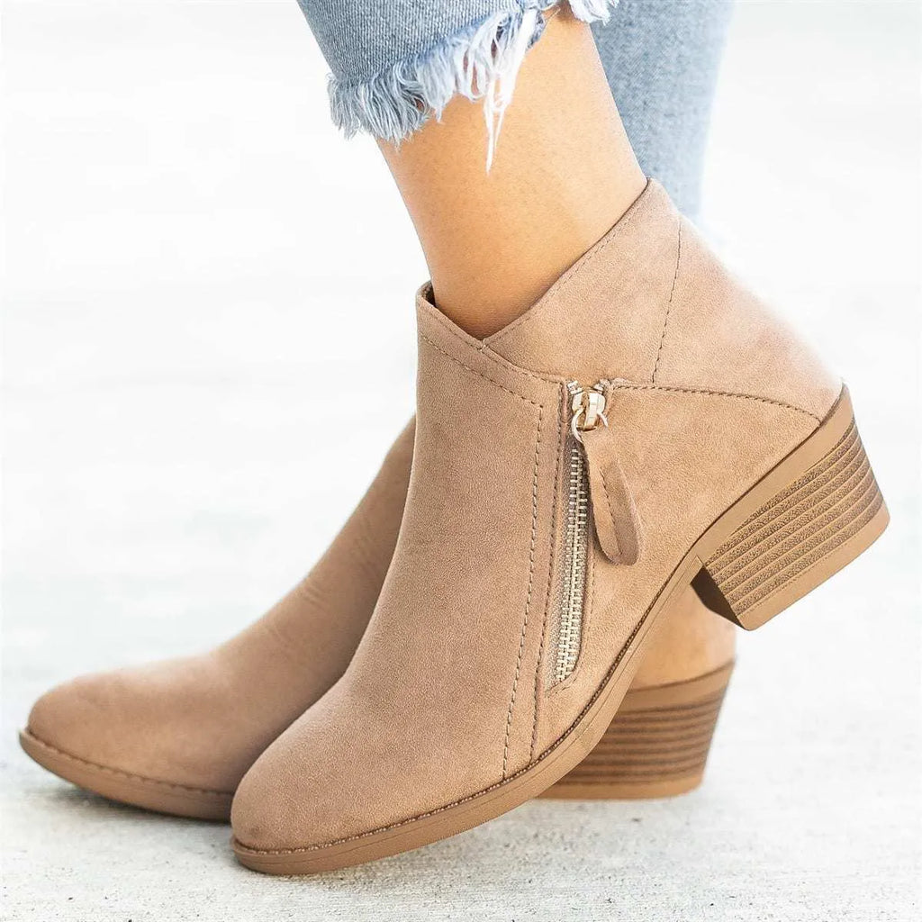 Blue suede women's ankle boots with a chunky heel and side zip closure on a white background.