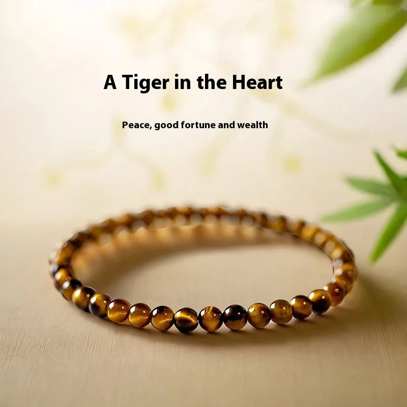 Tigereye stone bracelet with geometric Chinese design showing round elements and bead detailing