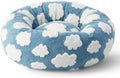 Round plastic dog bed with a blue and white plaid fabric cover, shown on a wooden floor.