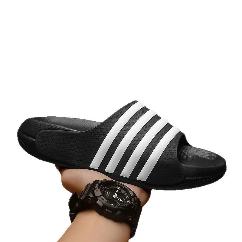 A pair of casual unisex slippers with an EVA sole and PVC upper, shown in a two-tone colour option.