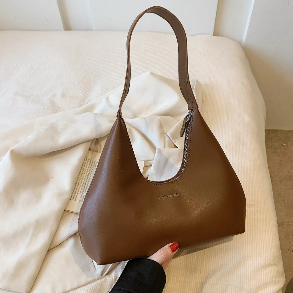 Retro style cream yellow PU shoulder handbag with single strap, sandwich pocket, and stitching detail.