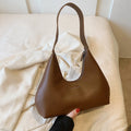 Retro style cream yellow PU shoulder handbag with single strap, sandwich pocket, and stitching detail.