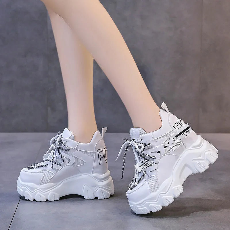 Women's white breathable mesh platform sports shoes with cross strap and rubber sole.