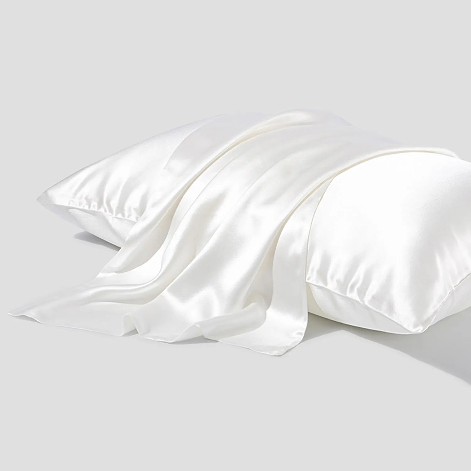 Solid colour mulberry silk envelope pillowcase in dark grey on a bed.