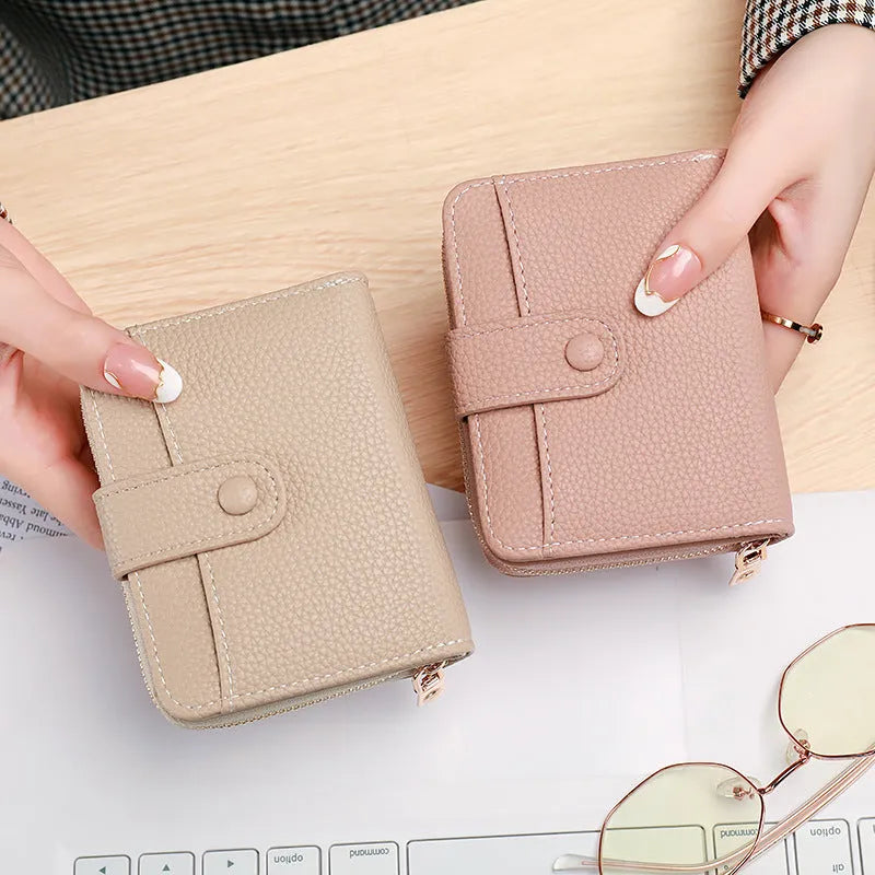 Ladies' short PU leather wallet with lychee pattern, shown in bifold open view.