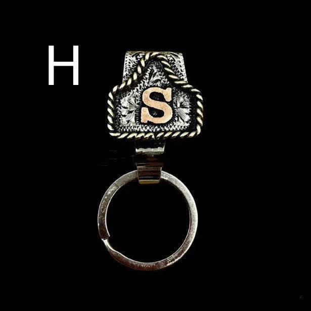 Handmade metal keychain with a cow tag charm in one of 26 available colour options.