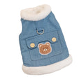 Denim dog vest with white wool lining, embroidered teddy bear patches, wooden buttons, and metal D-ring on blue background