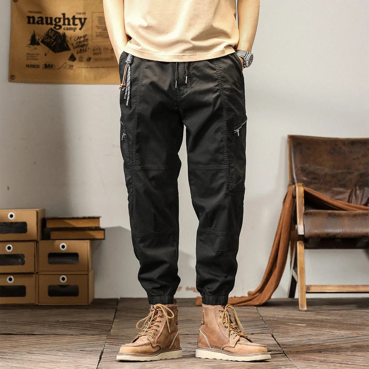 Men's loose fit cotton trousers with tapered ankle banded legs in khaki colour.