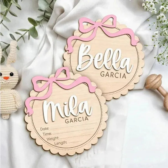 A square wooden ornament personalised with a baby's name for nursery decoration or photo prop.