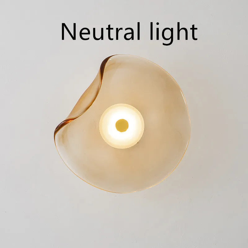 Round glass bedside wall lamp in cognac, light purple, or smoky grey colour.