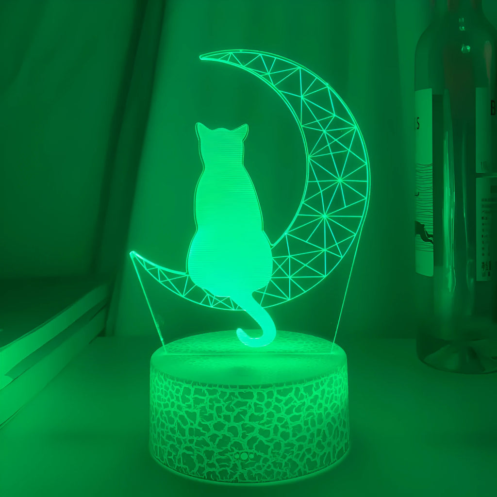3D LED light moon and cat shape acrylic panel with remote control and USB cable on a dark surface