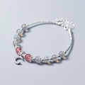Handmade adjustable moonstone bracelet with crescent moon charm and crystal bead on a white background.