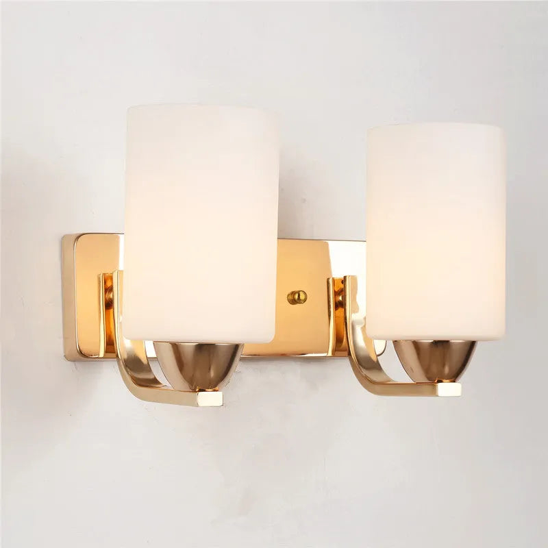 Minimalist chrome-finished glass wall lamp with single head configuration on white wall