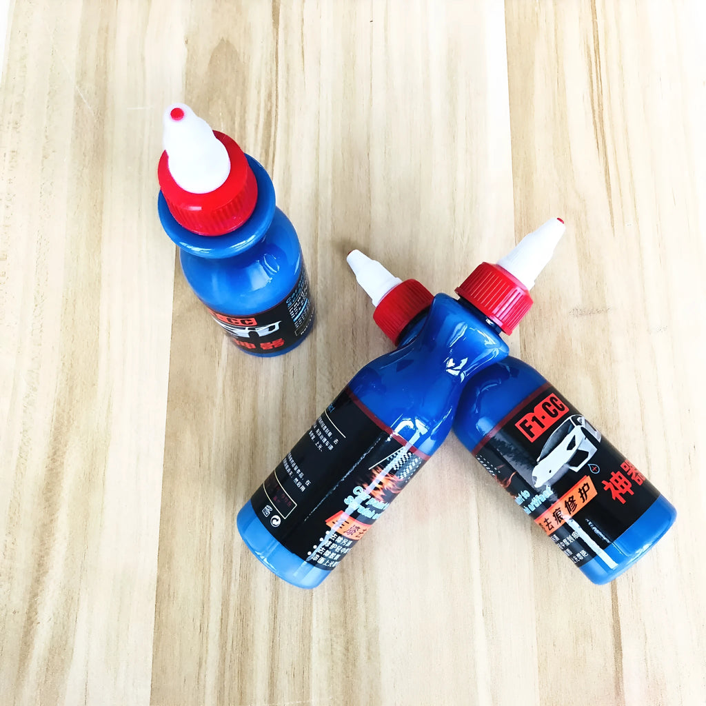 Small blue container of car scratch repair agent with sponge applicator for vehicle paint touch-ups